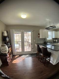 dining area featuring dark wood-type flooring