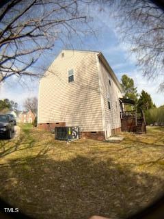 view of side of home featuring crawl space and central air condition unit