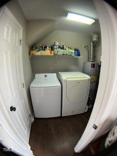 clothes washing area featuring laundry area, wood finished floors, separate washer and dryer, and water heater