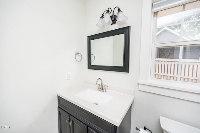 bathroom featuring toilet and vanity