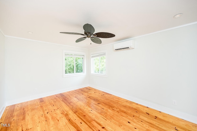 unfurnished room with crown molding, a wall mounted AC, hardwood / wood-style flooring, and ceiling fan