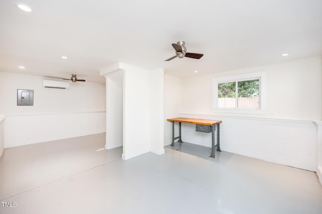 basement with a wall unit AC, ceiling fan, and electric panel