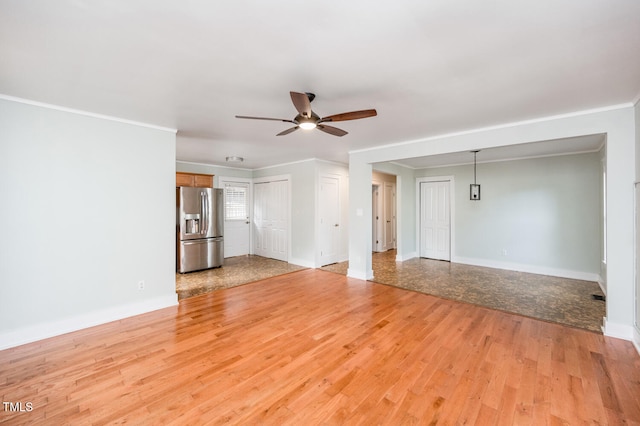 unfurnished living room with ceiling fan, crown molding, and light hardwood / wood-style floors