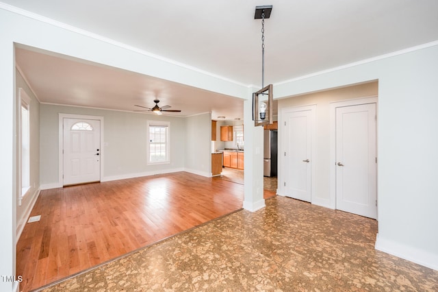 entryway featuring ceiling fan, ornamental molding, and hardwood / wood-style flooring