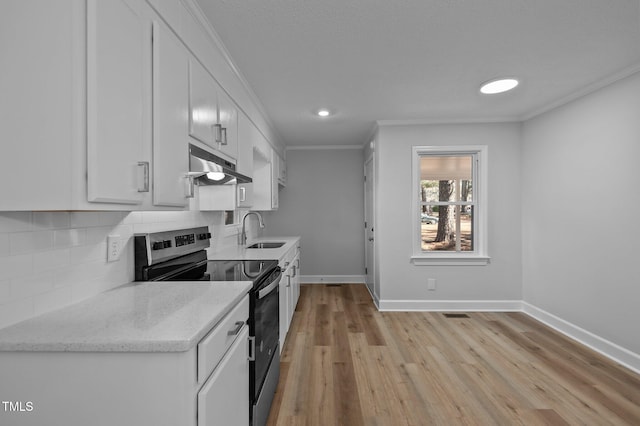 kitchen with backsplash, stainless steel electric range, sink, crown molding, and white cabinetry