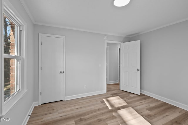 unfurnished bedroom with ornamental molding and light hardwood / wood-style floors