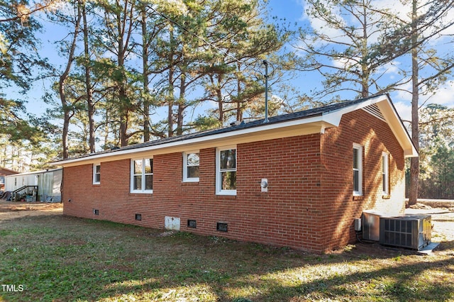 view of home's exterior featuring a lawn and central air condition unit