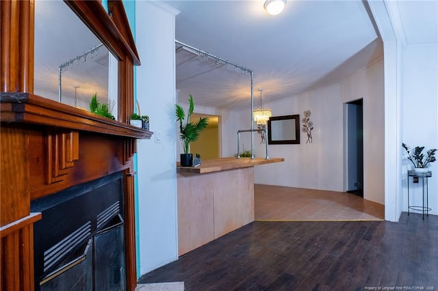 interior space featuring dark wood-type flooring, a chandelier, and pendant lighting