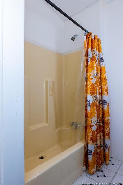 bathroom featuring tile patterned flooring and shower / tub combo with curtain