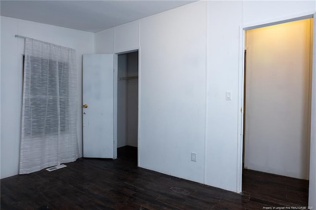 unfurnished bedroom featuring dark hardwood / wood-style floors