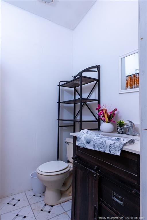 bathroom with toilet and vanity