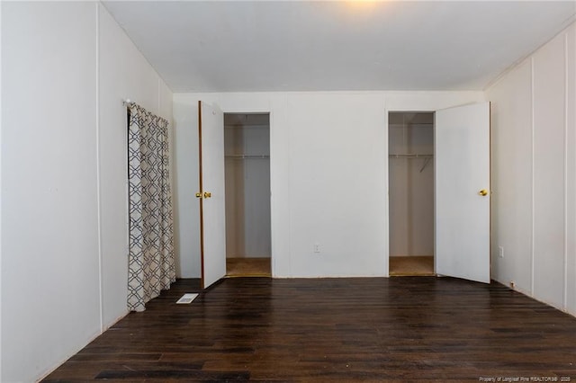 unfurnished bedroom with dark wood-type flooring