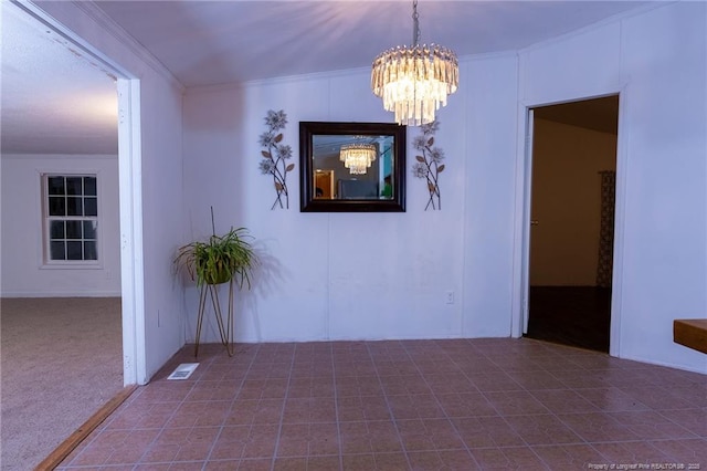 unfurnished dining area featuring ornamental molding and an inviting chandelier