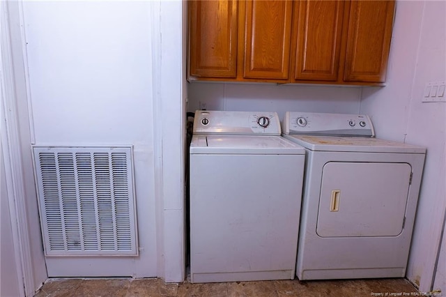 washroom featuring washing machine and dryer and cabinets