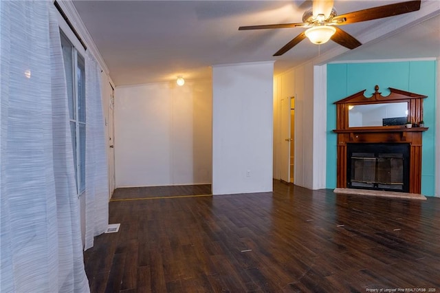 unfurnished living room with ceiling fan, crown molding, and dark hardwood / wood-style flooring