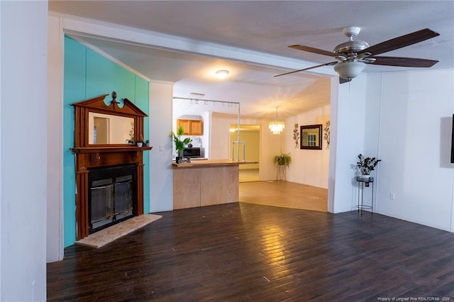 living room with ceiling fan with notable chandelier and dark wood-type flooring