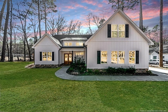 back house at dusk with a yard