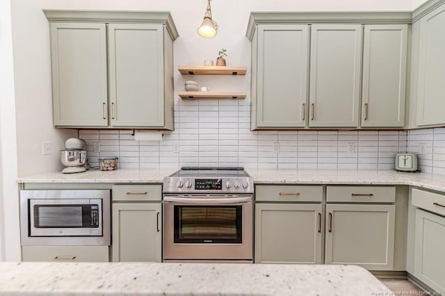 kitchen featuring stainless steel appliances, pendant lighting, light stone countertops, and tasteful backsplash