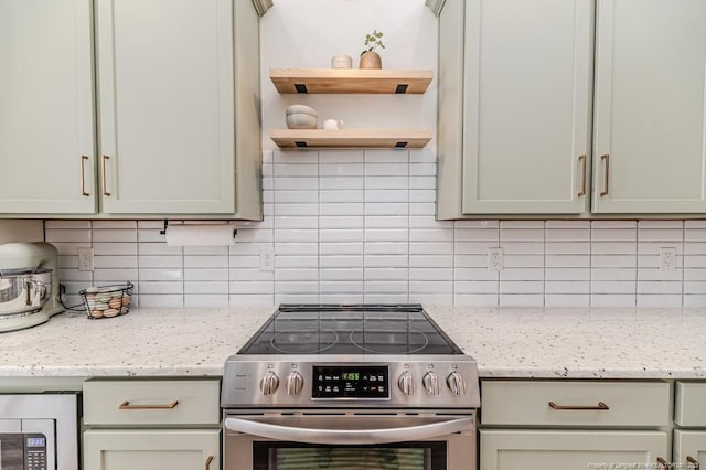 kitchen featuring stainless steel range with electric cooktop, tasteful backsplash, and light stone countertops