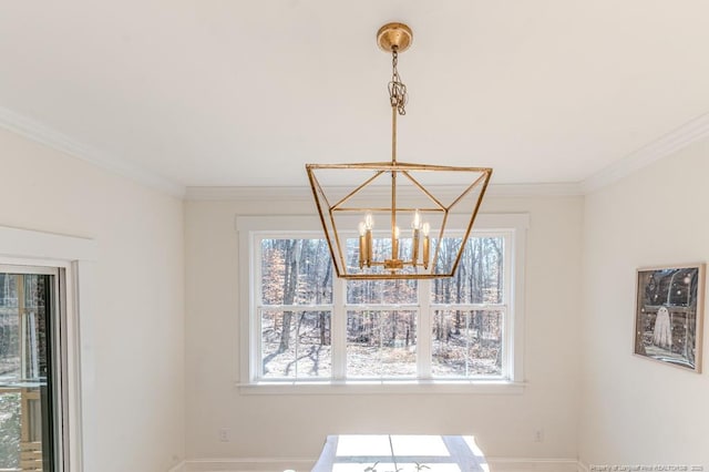 details featuring ornamental molding and a chandelier