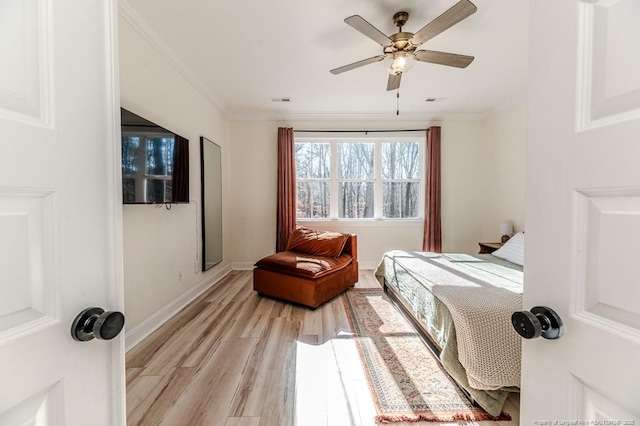 bedroom featuring ceiling fan, light hardwood / wood-style floors, and crown molding