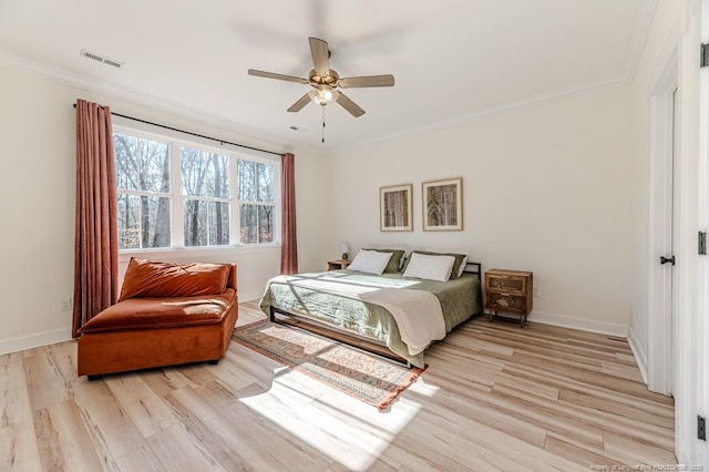 bedroom with ceiling fan, light wood-type flooring, and crown molding