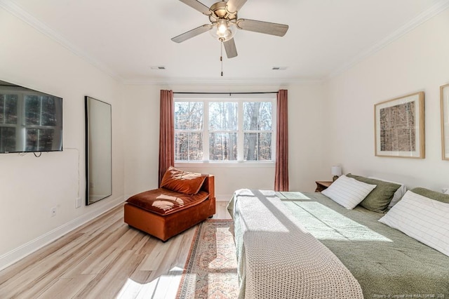 bedroom with ceiling fan, light hardwood / wood-style floors, and ornamental molding