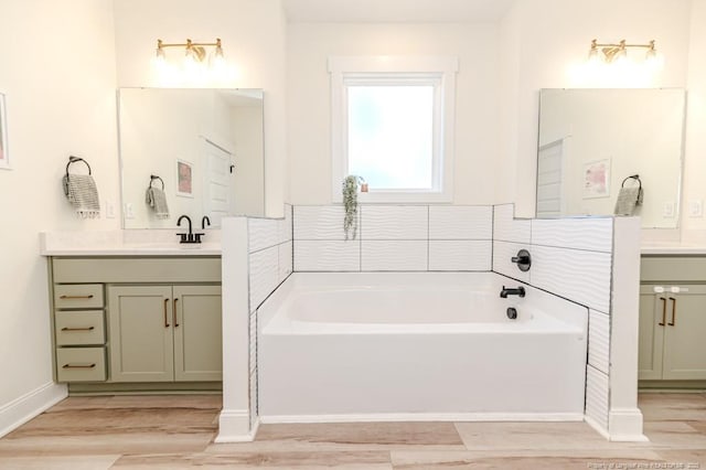 bathroom featuring vanity, hardwood / wood-style flooring, and a bathing tub