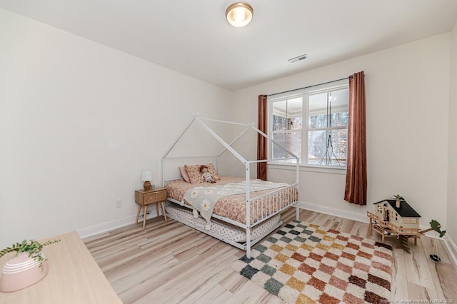 bedroom with light hardwood / wood-style floors