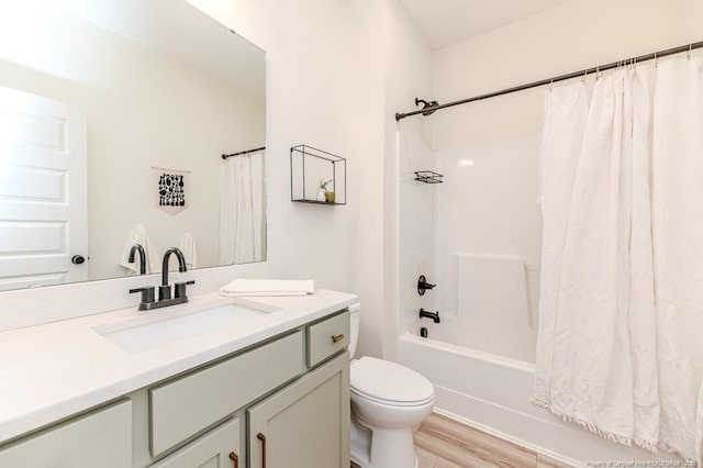 full bathroom with toilet, hardwood / wood-style flooring, shower / bath combination with curtain, and vanity