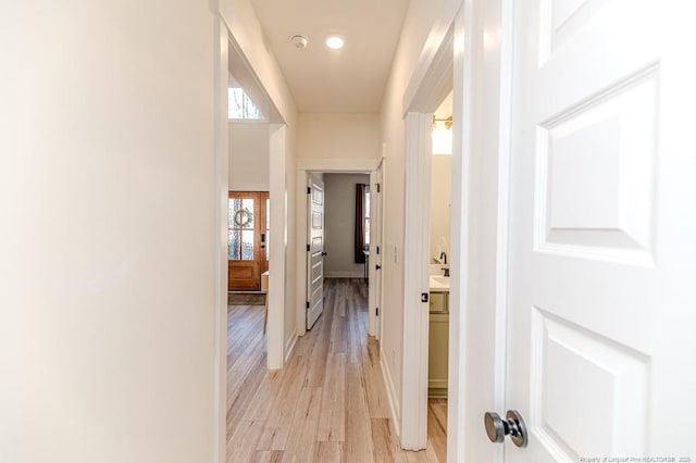 hallway with light hardwood / wood-style flooring