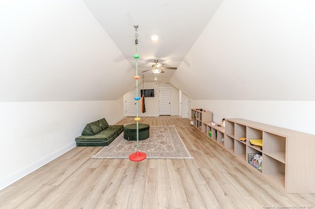 interior space featuring ceiling fan, light wood-type flooring, and vaulted ceiling