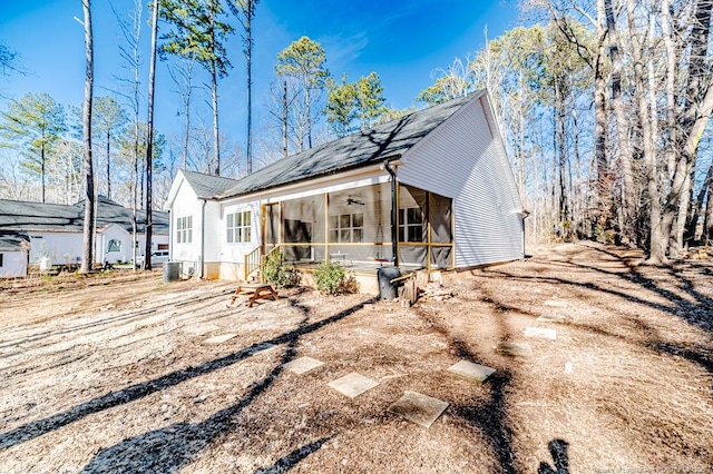 exterior space featuring central air condition unit, ceiling fan, and a sunroom