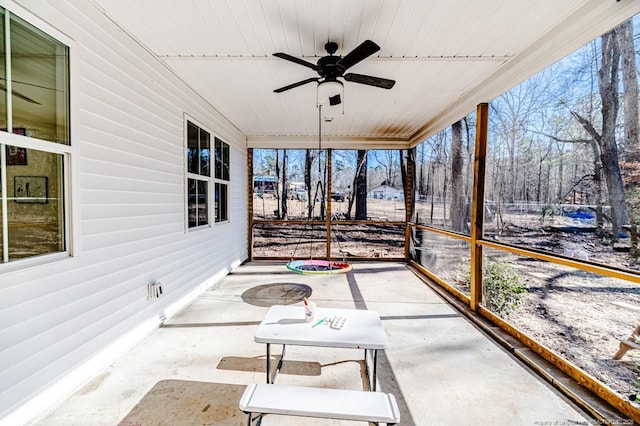 sunroom / solarium featuring ceiling fan and a healthy amount of sunlight