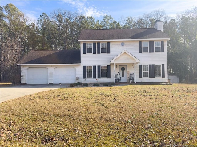 colonial home with a front yard and a garage