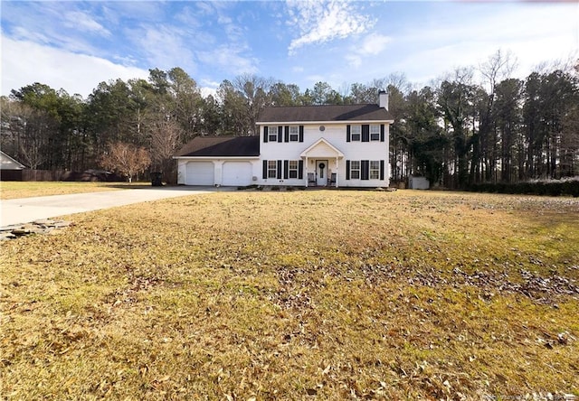 colonial inspired home featuring a front yard and a garage