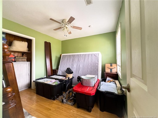 bedroom with ceiling fan and light hardwood / wood-style floors