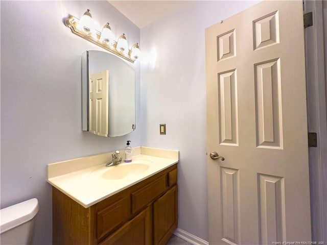 bathroom featuring vanity and toilet