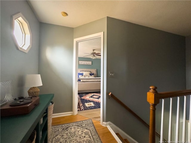 corridor with light hardwood / wood-style floors