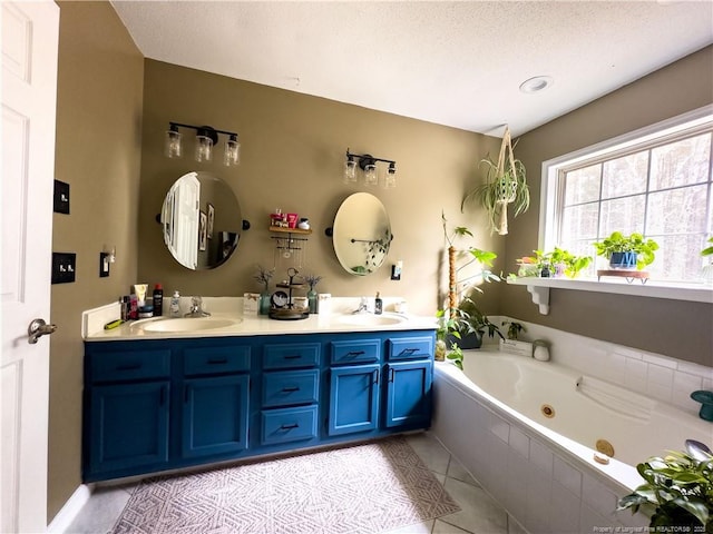 bathroom featuring vanity, tile patterned floors, a relaxing tiled tub, and a textured ceiling