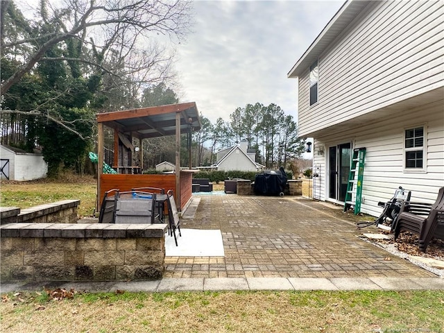 view of patio featuring grilling area and a hot tub