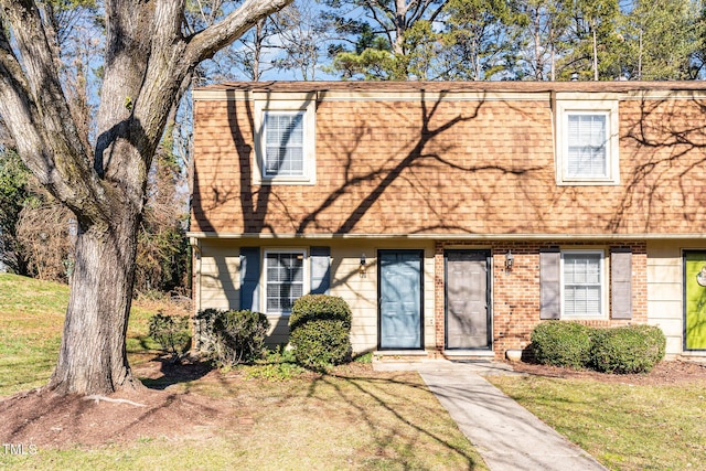 view of property featuring a front lawn