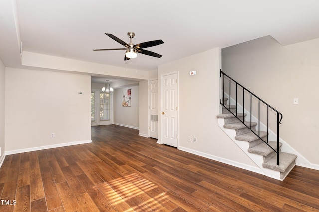 interior space with ceiling fan with notable chandelier and dark hardwood / wood-style floors