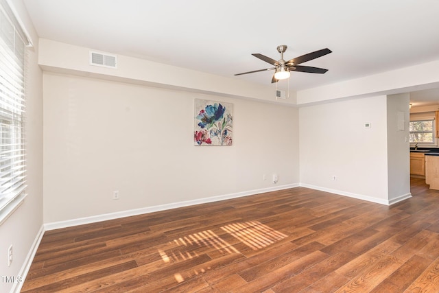 spare room featuring ceiling fan and dark hardwood / wood-style flooring