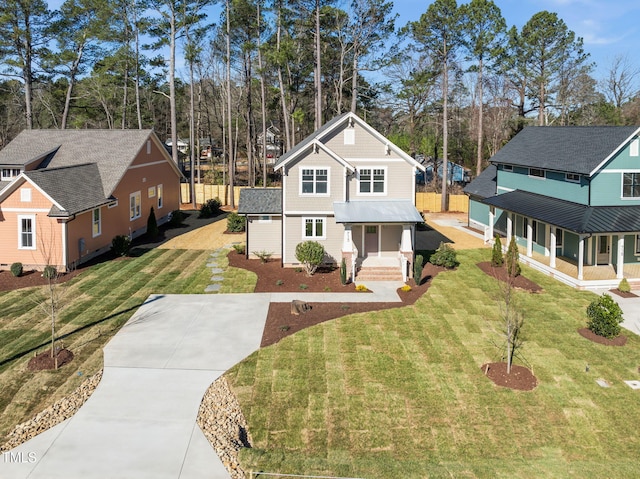 view of front of home with a porch, concrete driveway, and a front yard