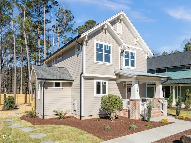 craftsman-style house featuring a shingled roof, covered porch, and crawl space