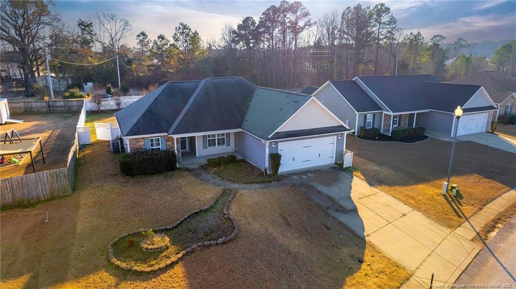 view of front of property featuring a garage and a yard