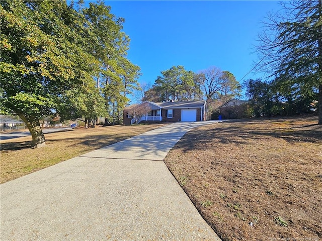 view of front of house featuring a front lawn and a garage