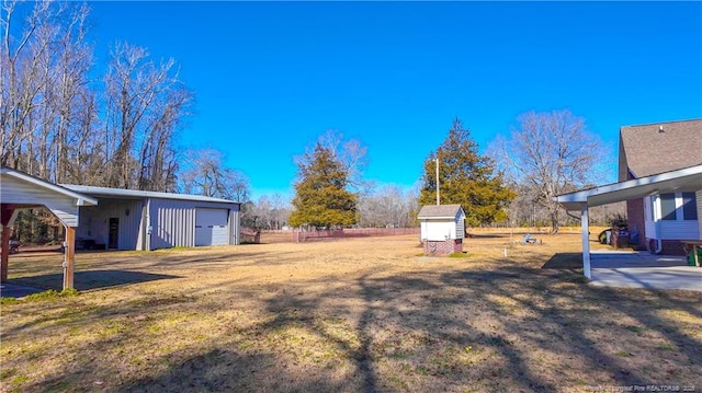 view of yard with a storage shed and a garage