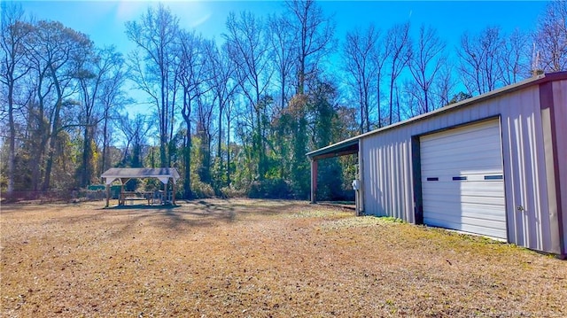 view of yard featuring an outbuilding and a garage